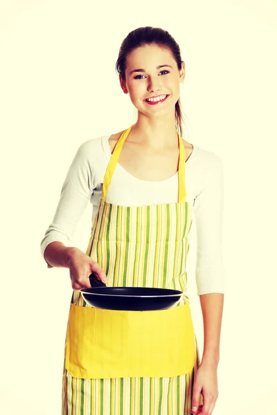 Smiling female teen with a frying pan. — Stock Photo, Image