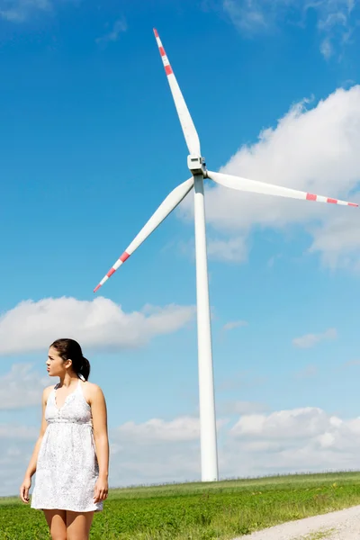 Joyeux adolescent fille à côté de éolienne . — Photo