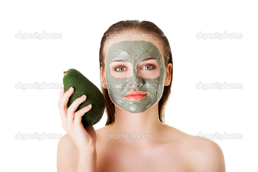 Spa woman in facial mask and avocado