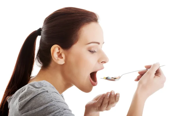 Woman taking pills — Stock Photo, Image