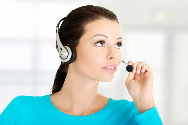 Beautiful young call-center assistant smiling Stock Picture