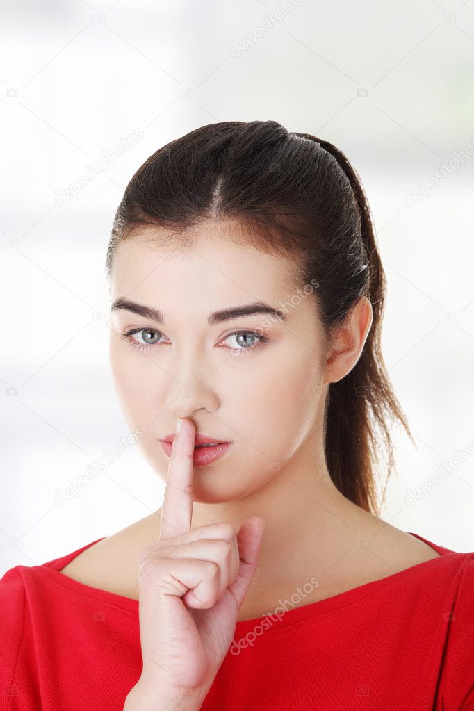Woman making a keep it quiet gesture
