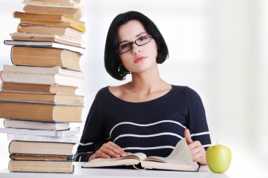 Young student woman studying at the desk clipart