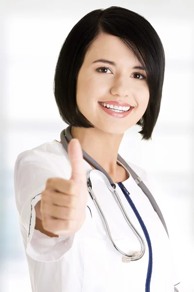 Junge Ärztin oder Krankenschwester gestikuliert ok — Stockfoto