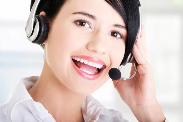 Beautiful young call-center assistant smiling — Stock Photo, Image