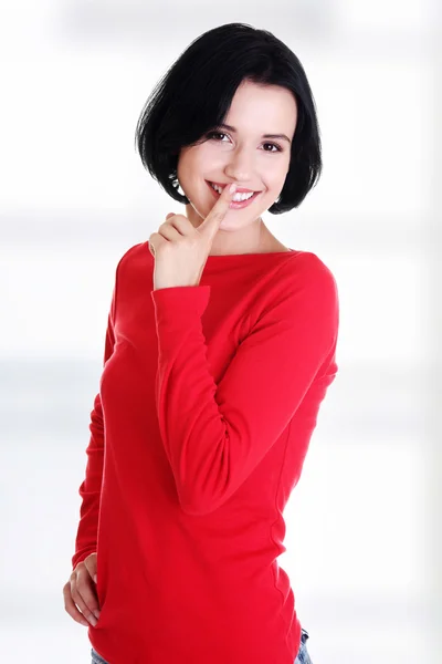 Happy woman making a keep it quiet gesture — Stock Photo, Image