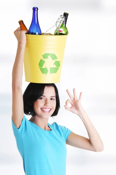 Beautiful woman holding recycling basket — Stock Photo, Image