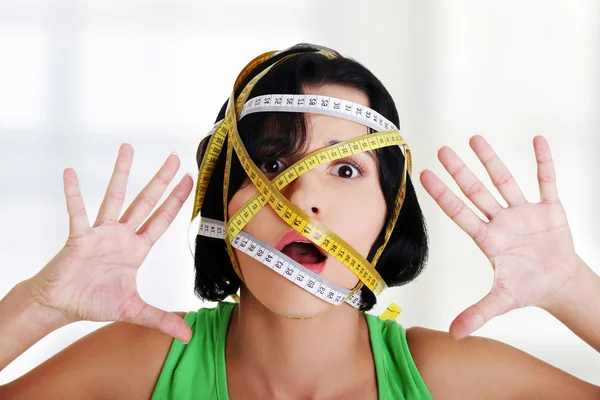 Woman with measuring tape around her head — Stock Photo, Image