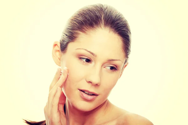 Beautiful young woman with cream — Stock Photo, Image