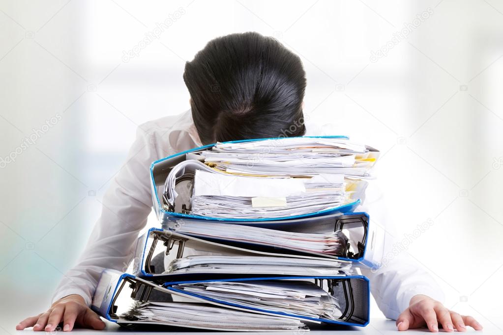 To much work to do. Sad woman with ringbinders