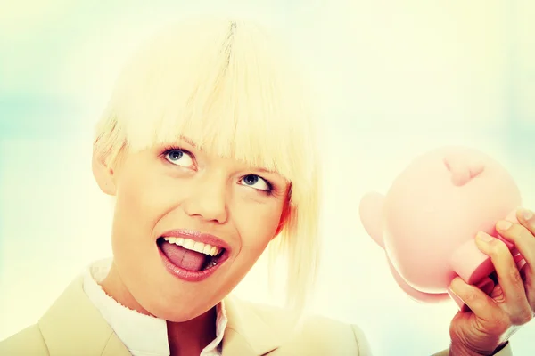 Businesswoman holding piggy bank — Stock Photo, Image