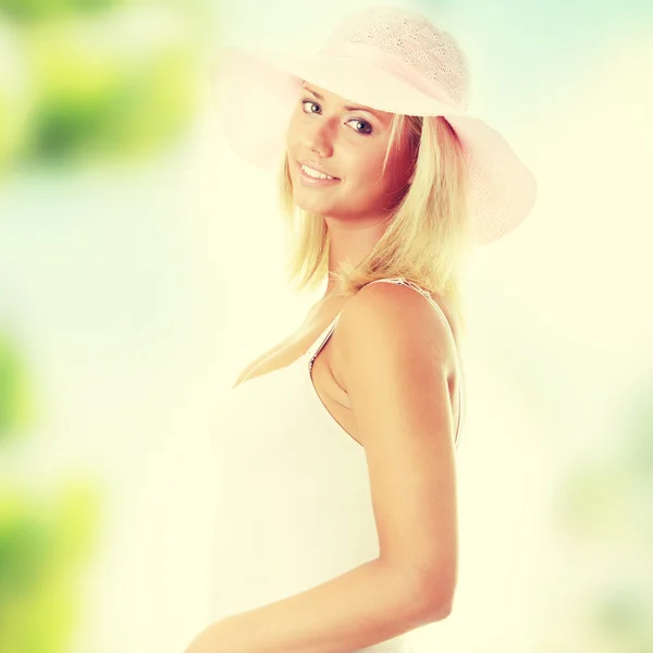 Woman wearing a pink straw hat — Stock Photo, Image