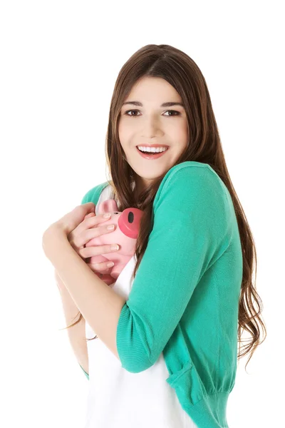 Young casual woman holding piggy-bank. — Stock Photo, Image