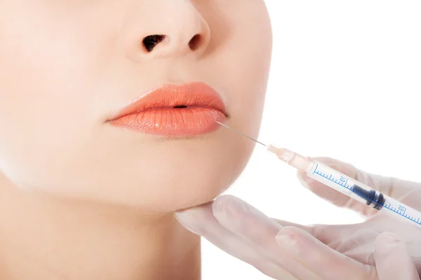 Young beautiful woman doing injection into mouth. — Stock Photo, Image