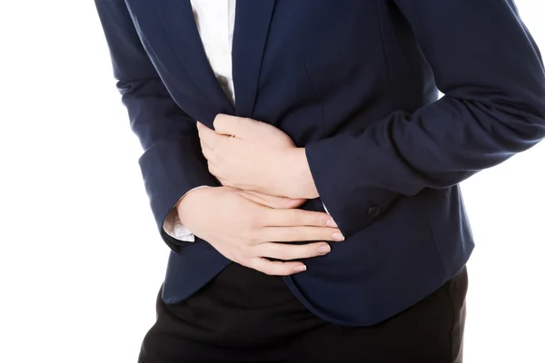 Beautiful business woman is touching her stomach. — Stock Photo, Image