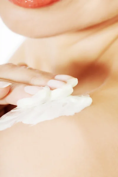 Woman applying body lotion on arm. — Stock Photo, Image
