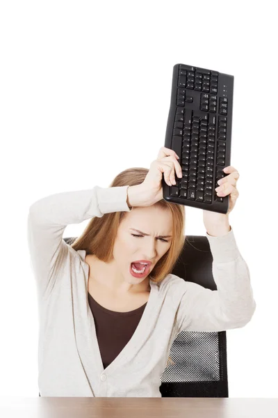 Woman trying to broke the keyboard — Stock Photo, Image