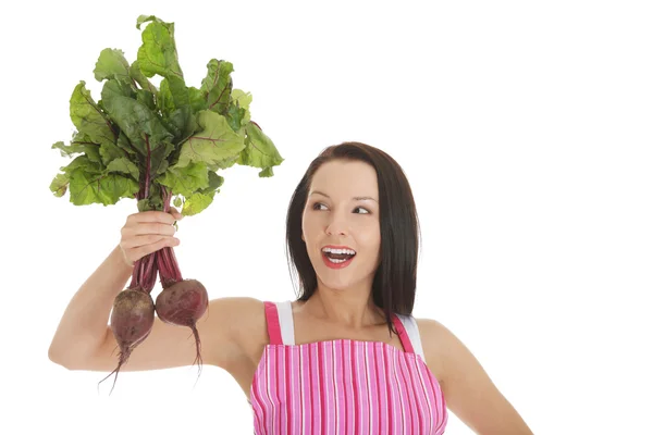 Young woman in apron and holding beetroots. — Stock Photo, Image