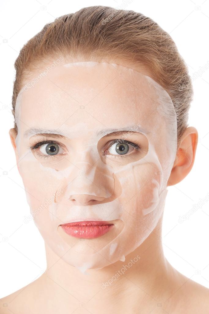 Beautiful young woman with collagen mask.