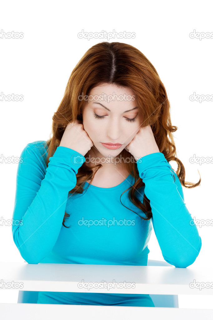 Woman sitting with her head down.