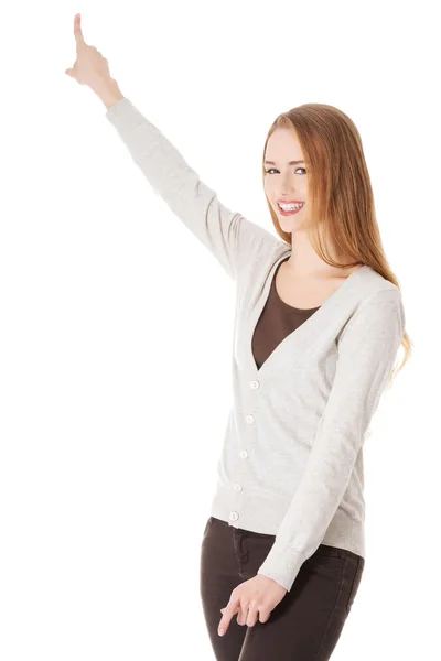Woman is pointing up and advertising. — Stock Photo, Image