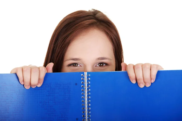 Woman behind blue workbook. — Stock Photo, Image