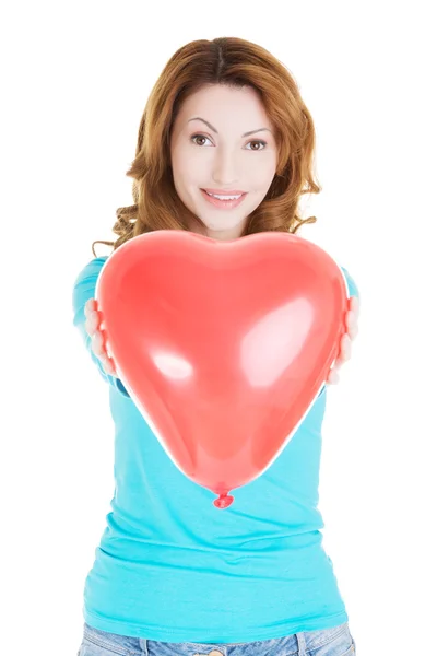 Woman giving a baloon heart. — Stock Photo, Image