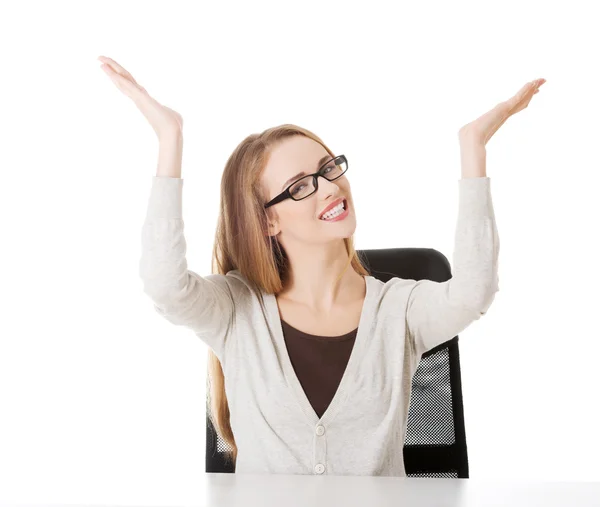 Woman sitting and pointing up, advertising — Stock Photo, Image