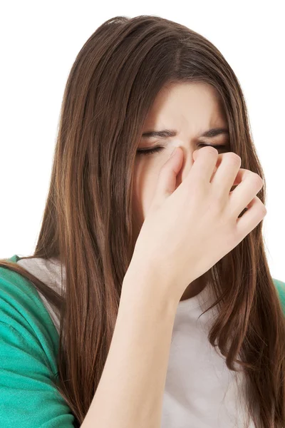 Woman with sinus pressure, touching her nose. — Stock Photo, Image