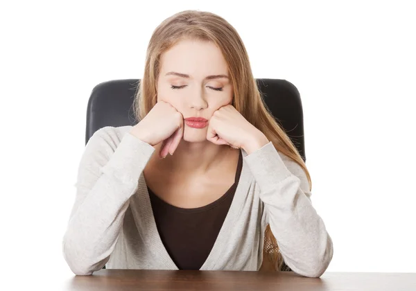 Bored or sleeping student woman by a desk. — Stock Photo, Image