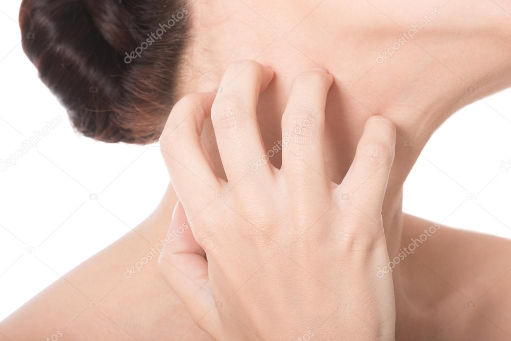 Woman is scratching her neck.