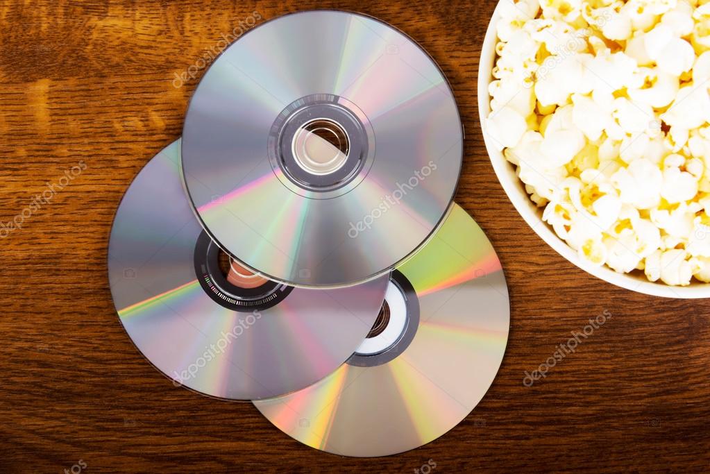 Picture of popcorn in a bowl and CDs.