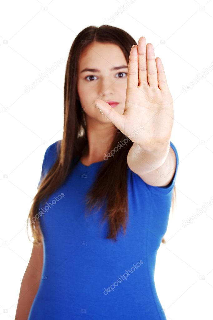 Beautiful casual woman showing stop gesture.