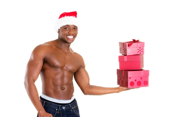 Man holding gifts and holding santa hat. — Stock Photo, Image