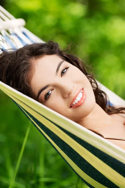 Young woman lying in a hammock — Stock Photo, Image