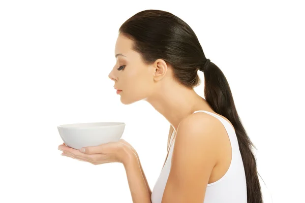 Beautiful young woman holding bowl — Stock Photo, Image