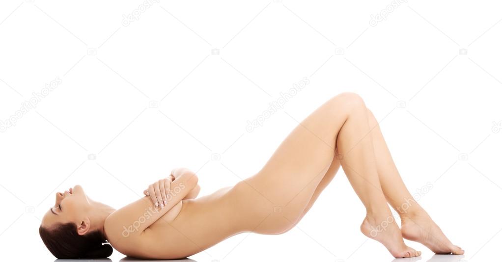 Sexy fit naked woman lying down.