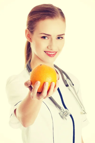 Лікар або медсестра тримає апельсин . — стокове фото