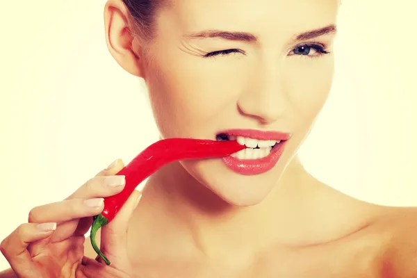 Woman with chili pepper in mouth. — Stock Photo, Image