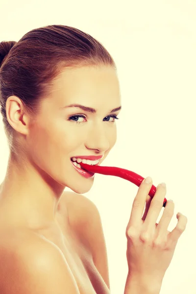 Woman with chili pepper in mouth. — Stock Photo, Image