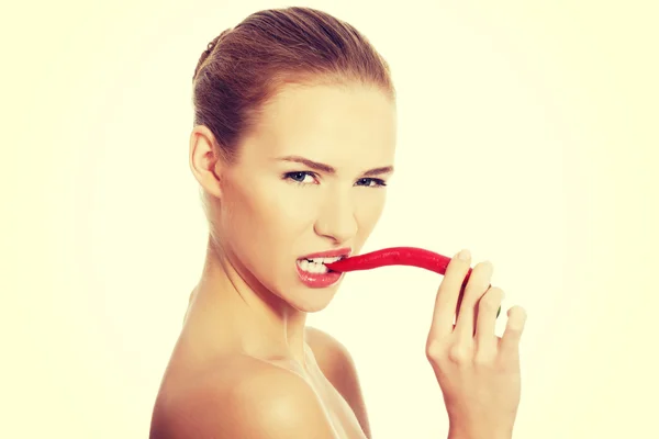 Woman with chili pepper in mouth. — Stock Photo, Image