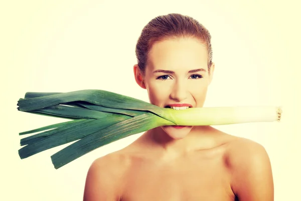 Woman with leek in mouth — Stock Photo, Image