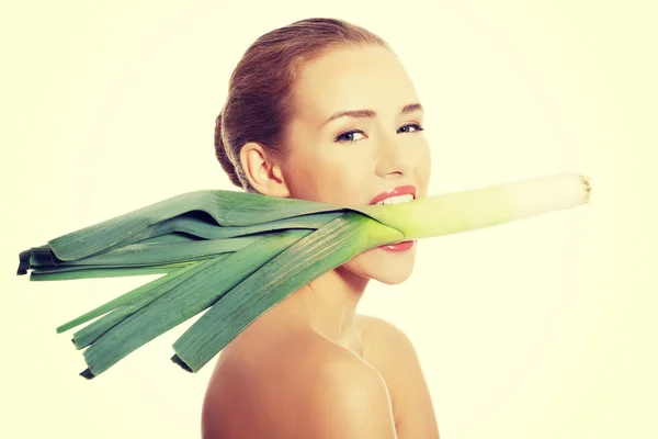 Woman with leek in mouth — Stock Photo, Image