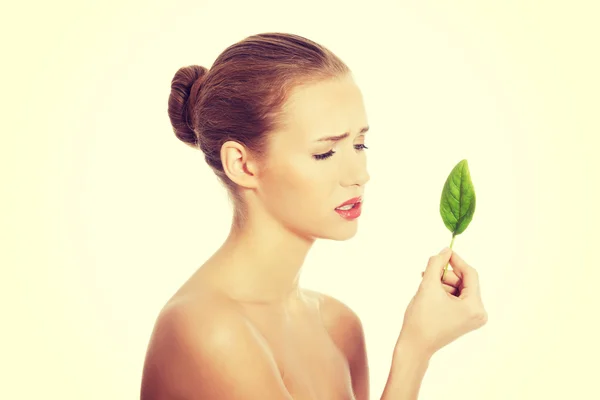 Woman with one green leaf. — Stock Photo, Image