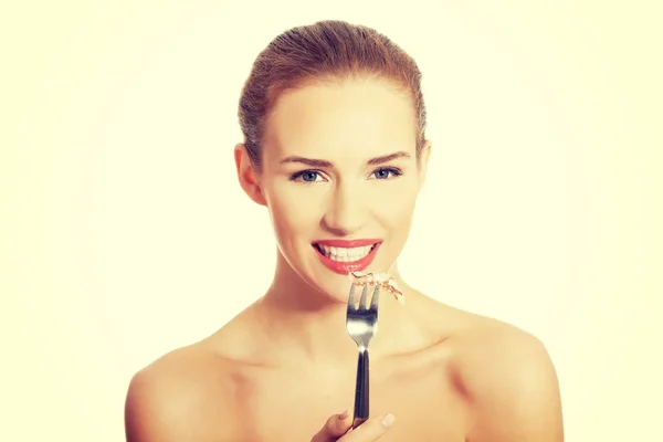 Woman eating sea fruit with fork. — Stock Photo, Image