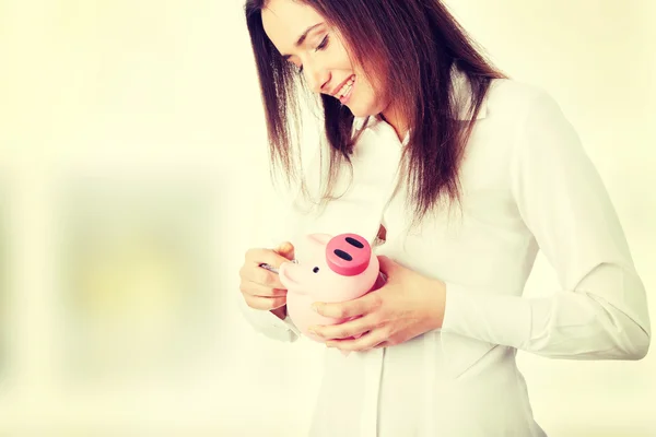 Woman standing with piggy bank — Stock Photo, Image