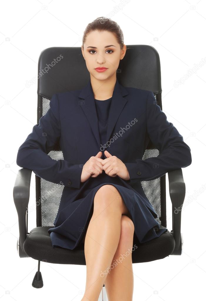 Business woman sitting in chair.