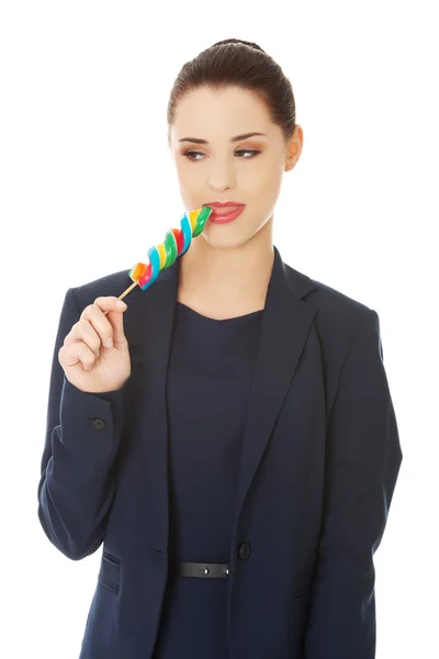 Beautiful businesswoman with lollipop — Stock Photo, Image