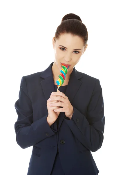 Beautiful businesswoman with lollipop — Stock Photo, Image