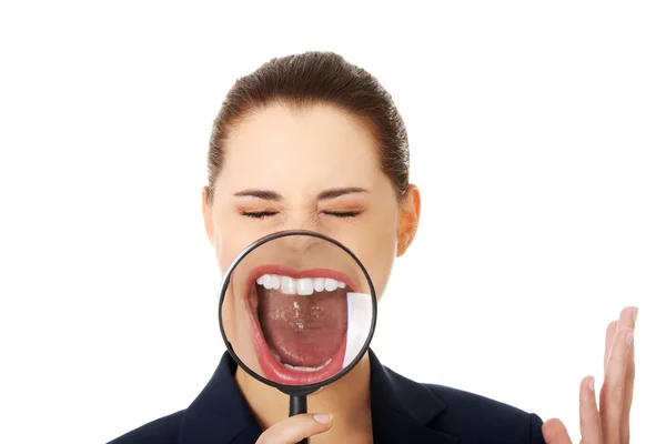 Business woman looking into a magnifying glass — Stock Photo, Image